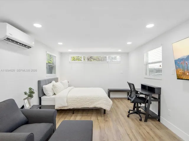 a bedroom with furniture and a wooden floor