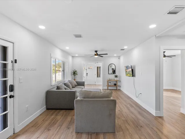a living room with furniture and a large window
