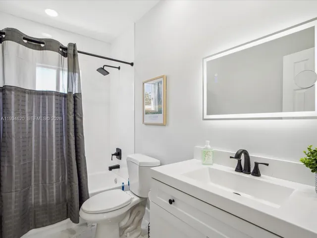 a white toilet sitting next to a bathroom sink