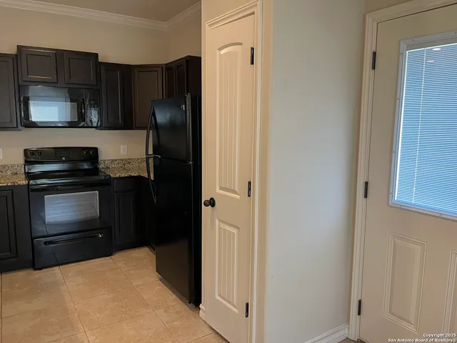 a kitchen with a refrigerator stove and microwave
