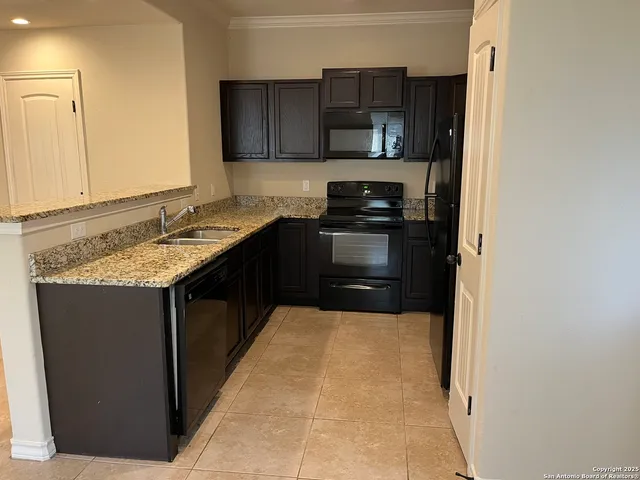 a kitchen with a sink and a stove