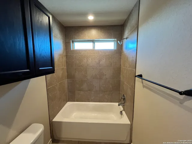 a bathroom with a tub and shower