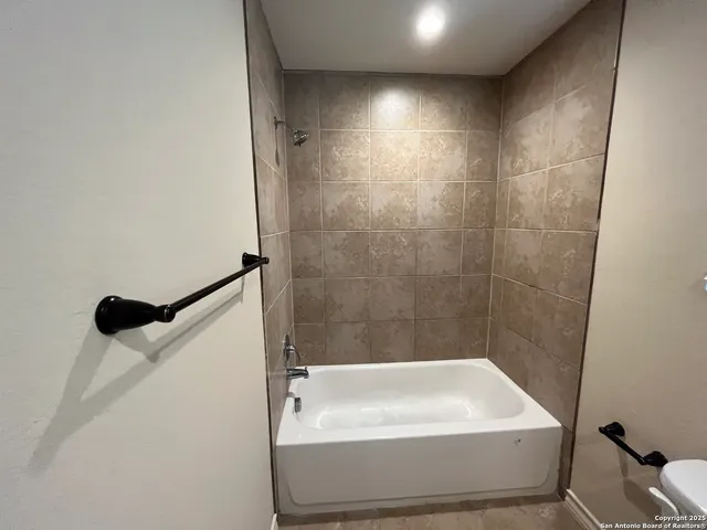 a bathroom with a bathtub and shower