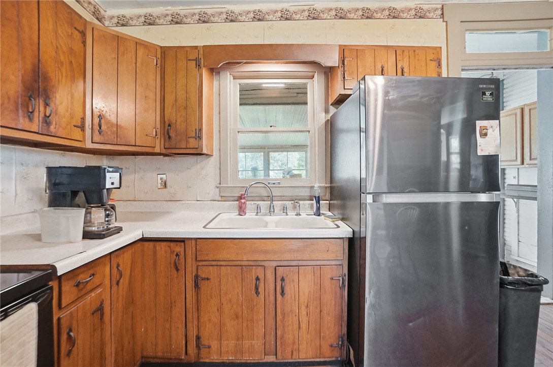 1444 Eagle City Road Springfield, OH 45504 - Photo 25 of 50 This cozy kitchen offers ample cabinet storage and a practical layout for everyday living.