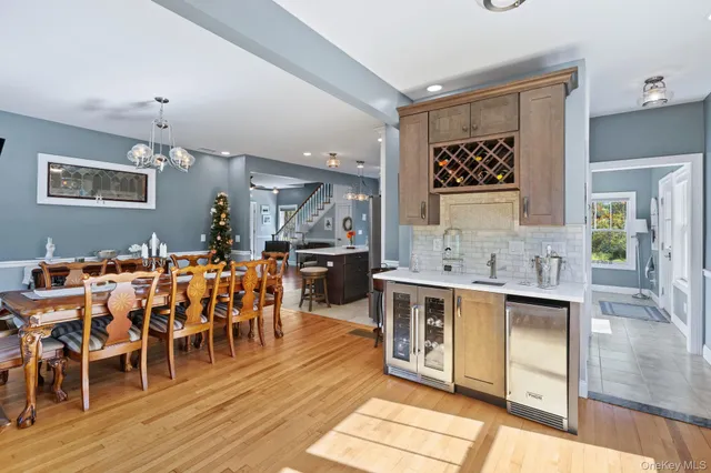 a view of kitchen with stainless steel appliances granite countertop a stove and a wooden floors