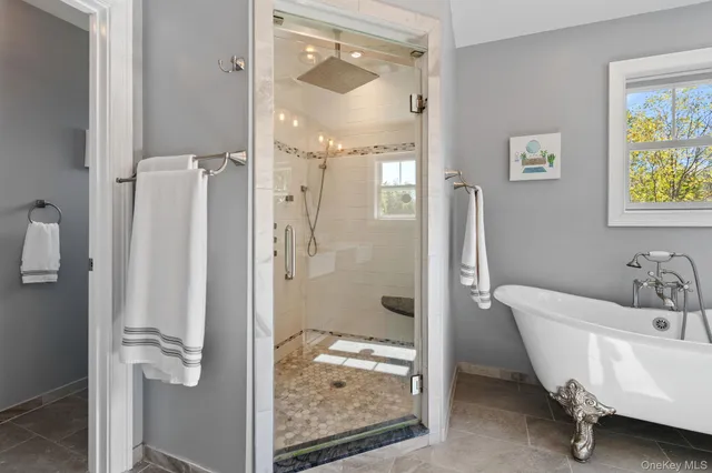 a white bath tub sitting next to a window