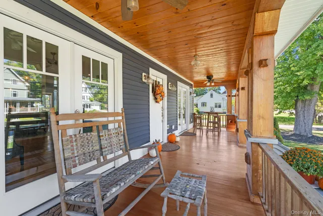 a outdoor dining space with furniture and wooden floor