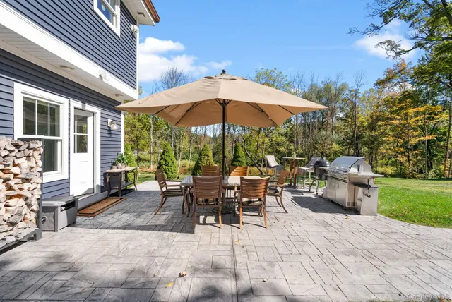 an aerial view of a house with a yard basket ball court and outdoor seating