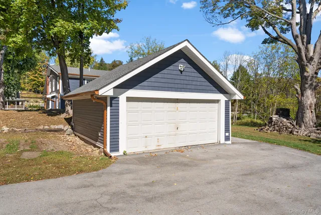 a view of a patio with table and chairs under an umbrella