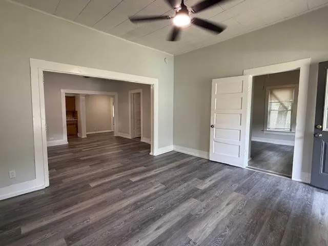 a view of empty room with wooden floor