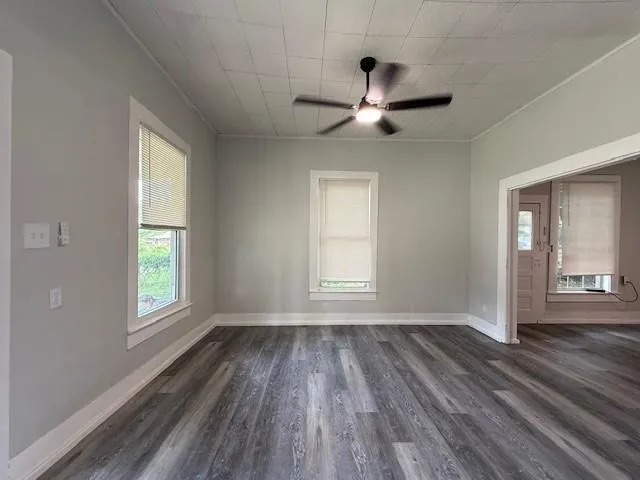 wooden floor in an empty room with a window