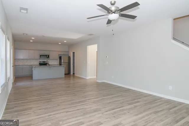 a kitchen with stainless steel appliances a sink stove and cabinets