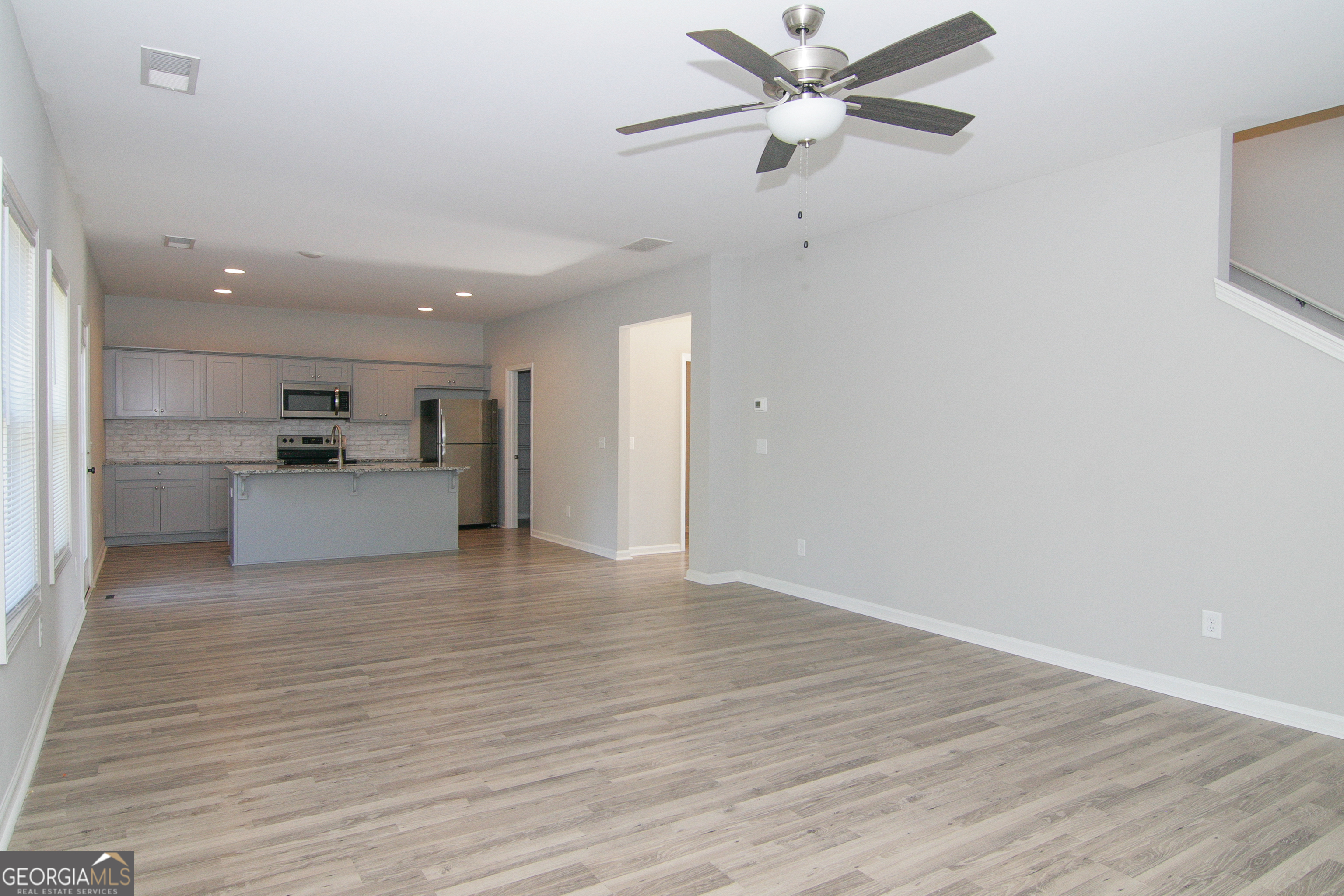 386 Springwater Way Bremen, GA 30110 - Photo 14 of 64 a view of a kitchen with a sink and a refrigerator