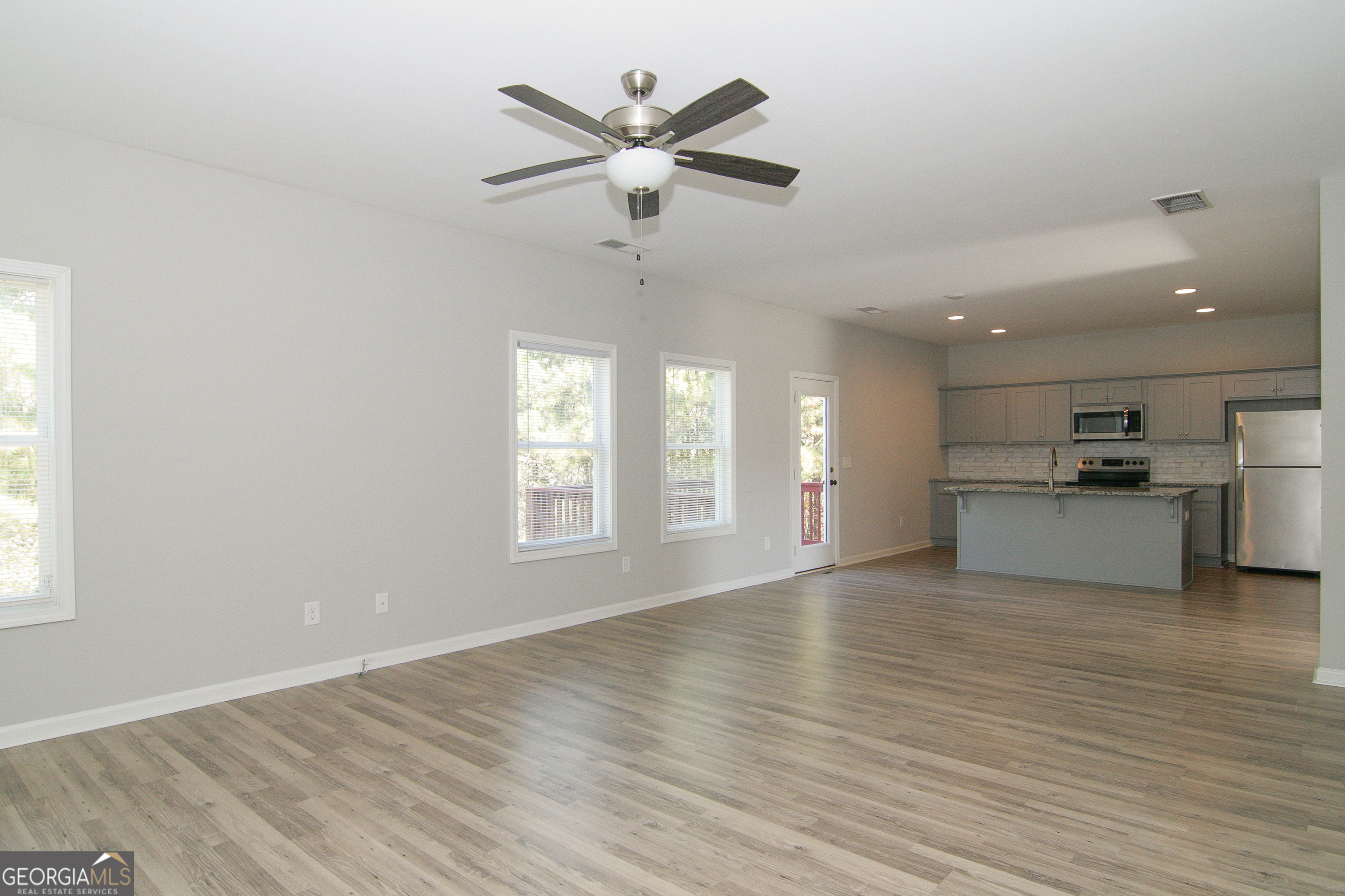 386 Springwater Way Bremen, GA 30110 - Photo 15 of 64 an empty room with wooden floor and windows
