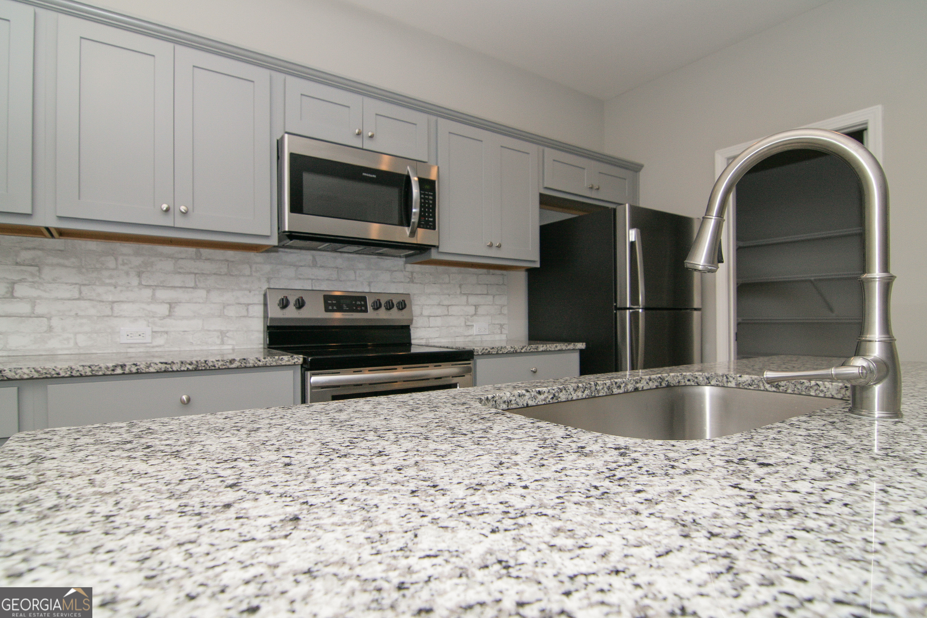 386 Springwater Way Bremen, GA 30110 - Photo 21 of 64 a kitchen with a sink a stove and cabinets