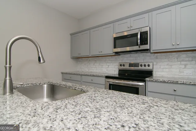 a kitchen with a refrigerator sink and stove
