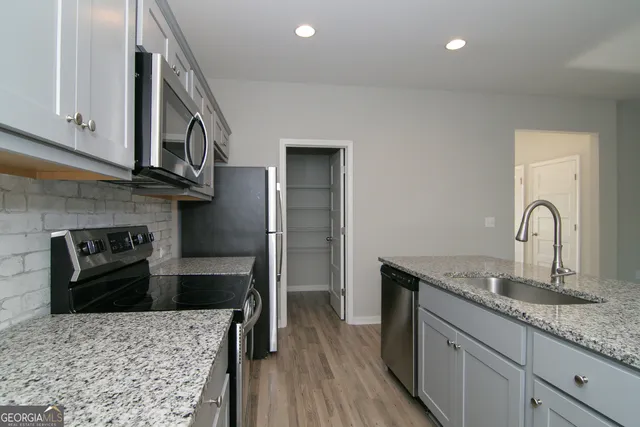 an empty room with windows and closet