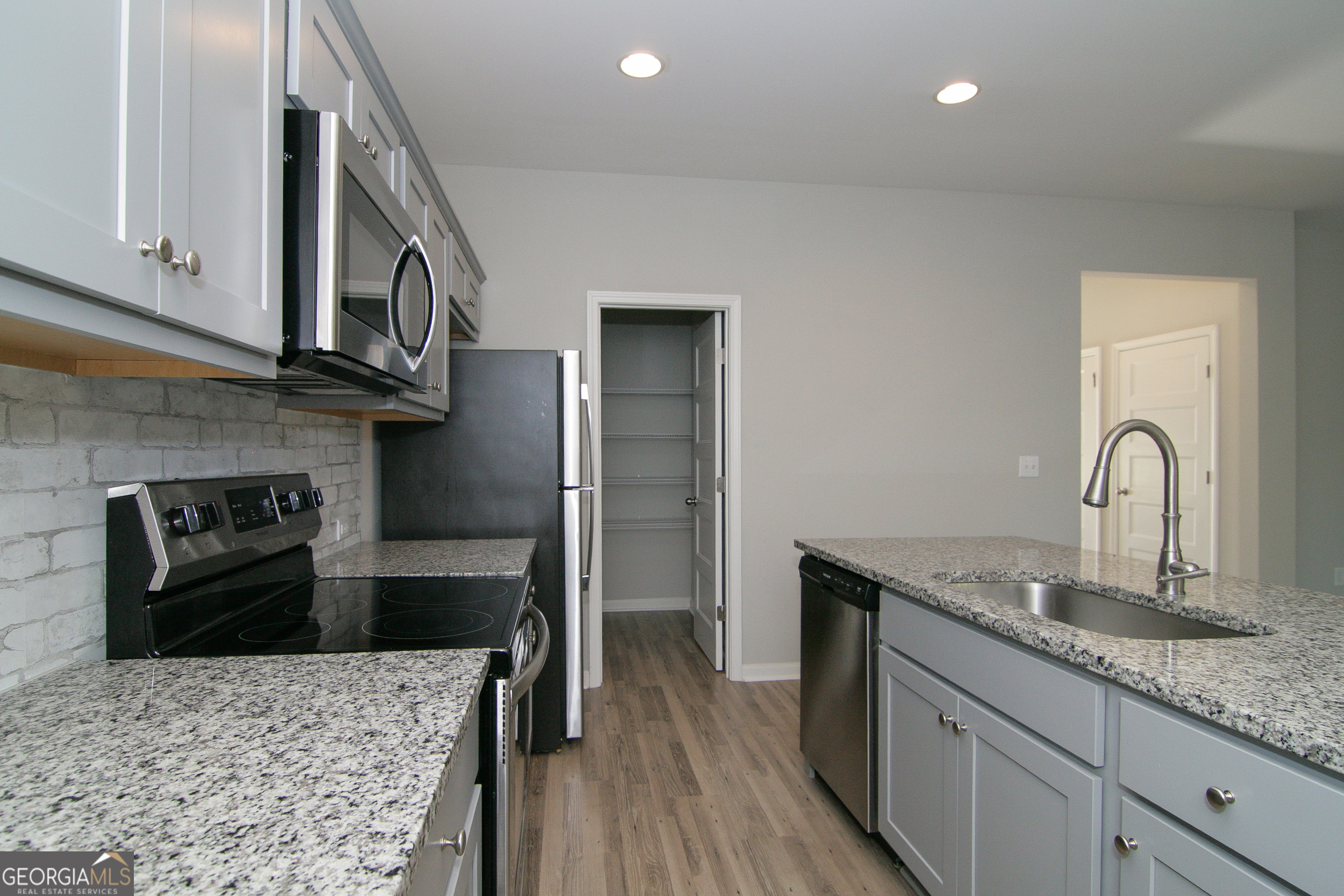 386 Springwater Way Bremen, GA 30110 - Photo 23 of 64 a kitchen with granite countertop a sink and a stove top oven