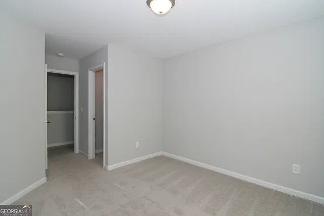 a bathroom with a granite countertop sink a mirror and a bathtub
