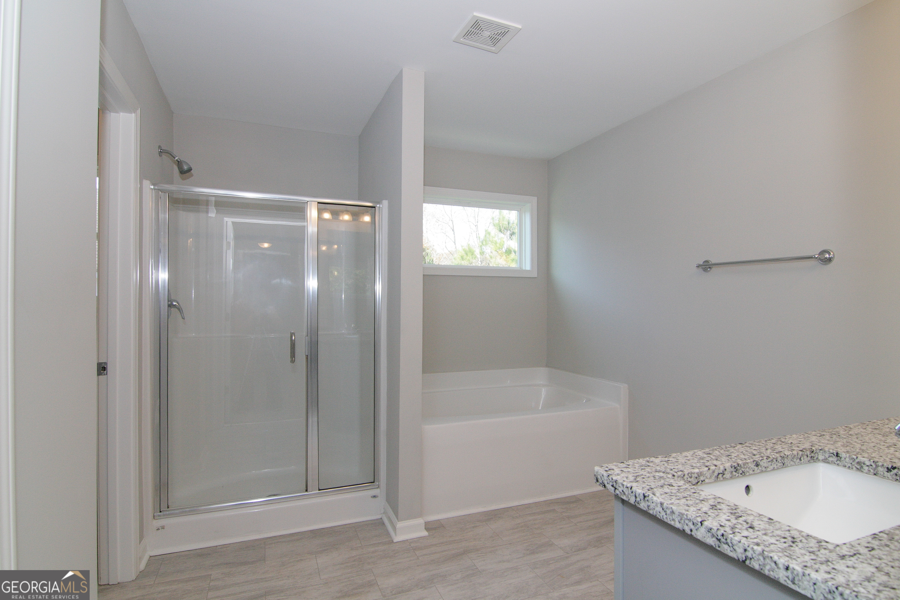 386 Springwater Way Bremen, GA 30110 - Photo 36 of 64 a bathroom with a granite countertop sink a mirror and a bathtub