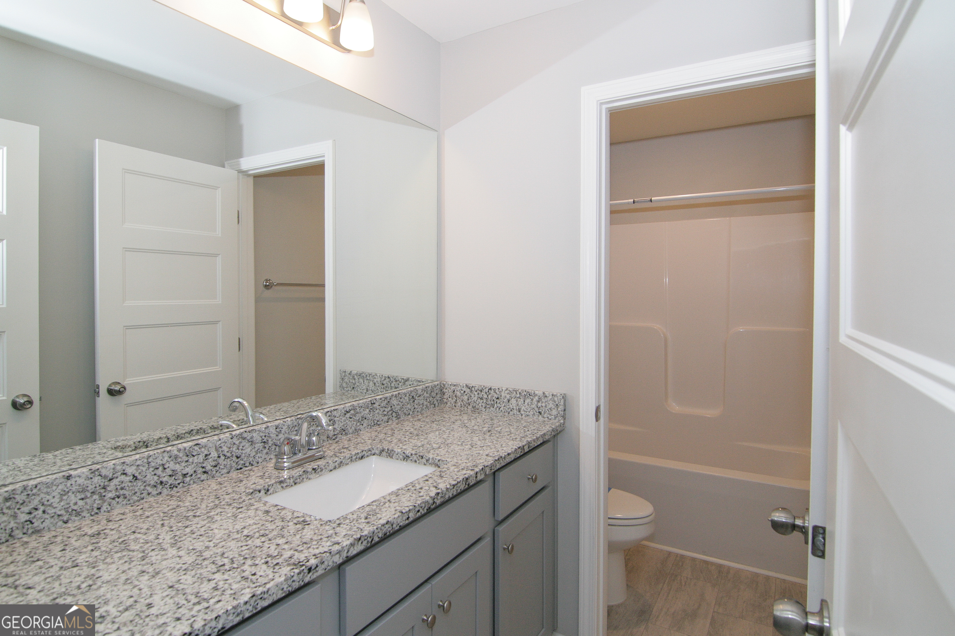 386 Springwater Way Bremen, GA 30110 - Photo 46 of 64 a bathroom with a granite countertop sink and a mirror