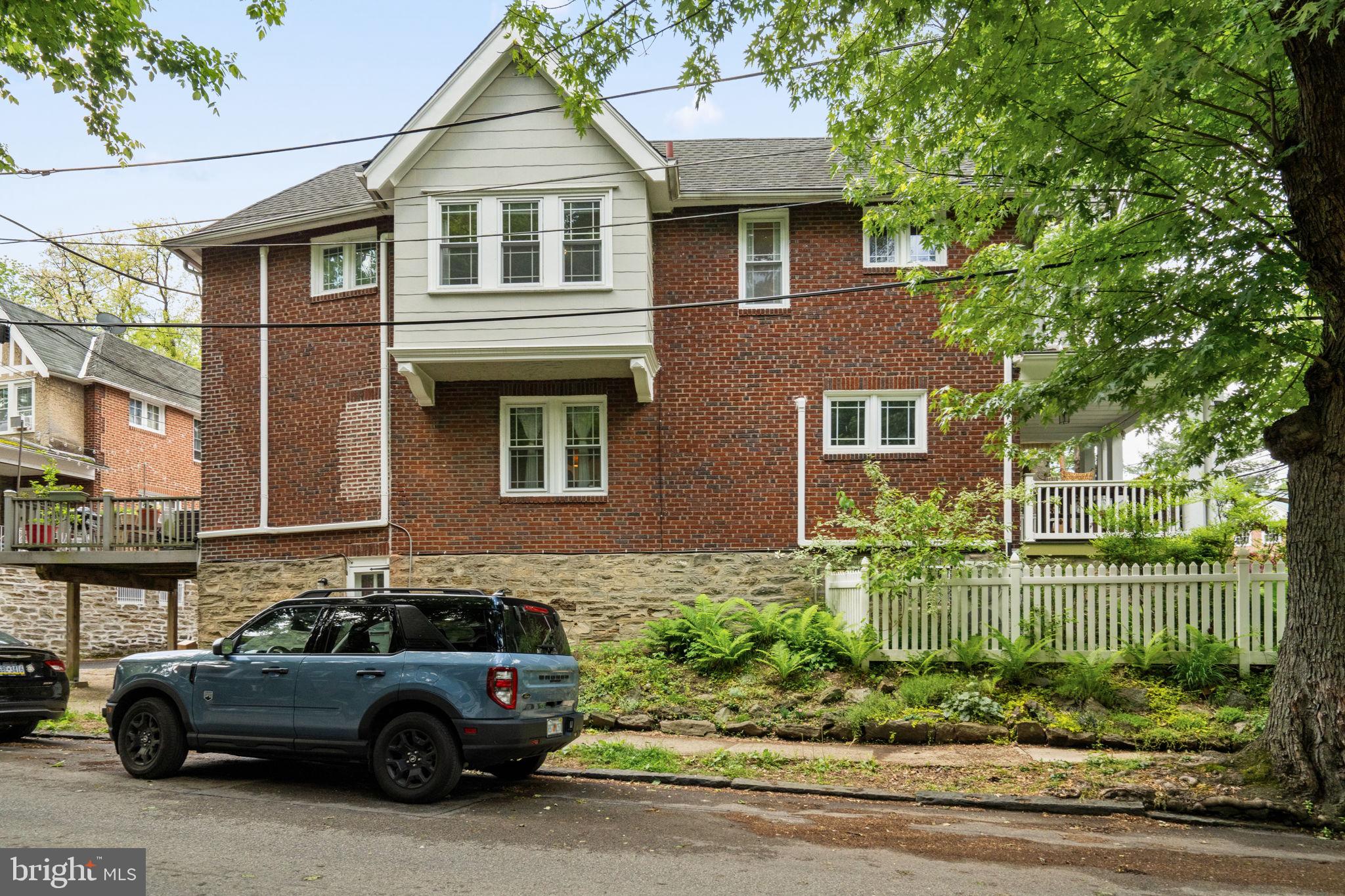 156 Roumfort Road Philadelphia, PA 19119 - Photo 54 of 56 a view of a car parked in front of a brick house