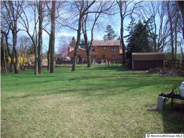 17 Laird Road Colts Neck, NJ 07722 - Photo 2 of 3 a backyard of a house with table and chairs