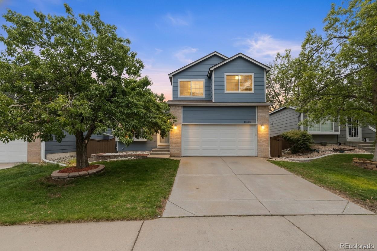 10565 Hyacinth Place Highlands Ranch, CO 80129 - Photo 1 of 33 a front view of a house with a garden