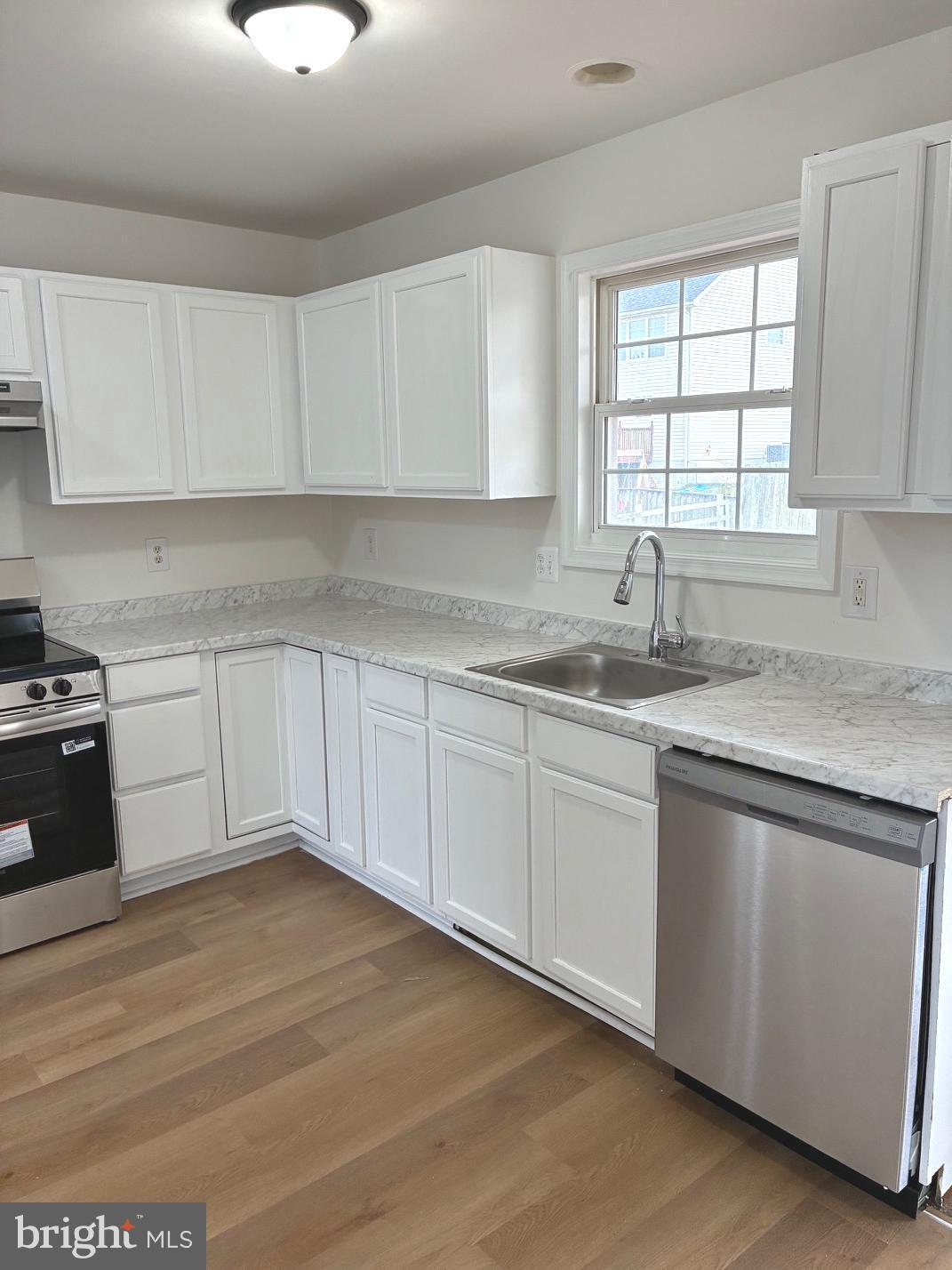 331 North Teal Road Martinsburg, WV 25405 - Photo 7 of 35 a kitchen with granite countertop white cabinets and white appliances