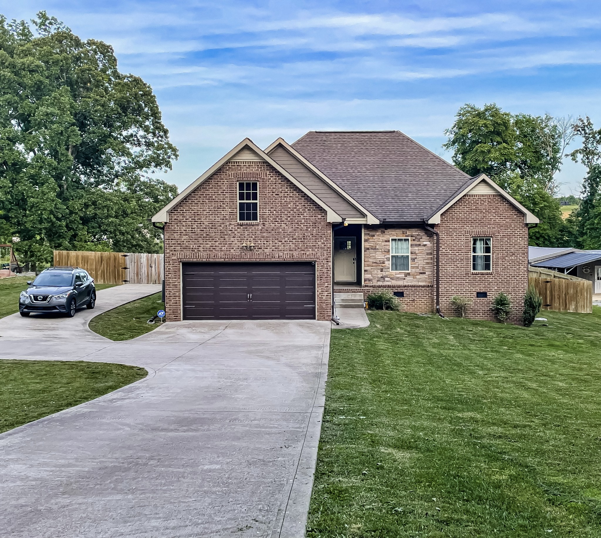419 Kaiser Road Dickson, TN 37055 - Photo 3 of 38 a front view of a house with a garden and yard