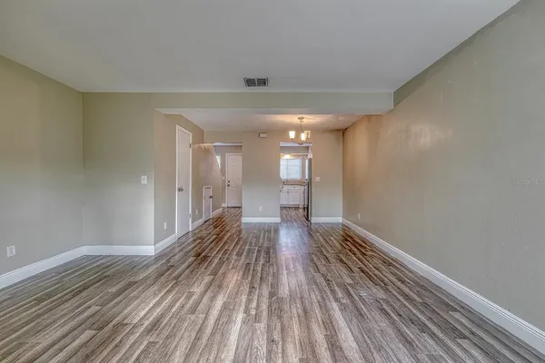 a view of a room with wooden floor