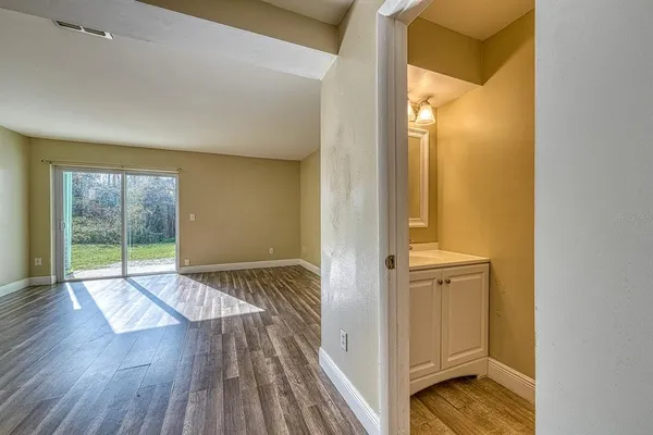 a view of wooden floor and windows in a room