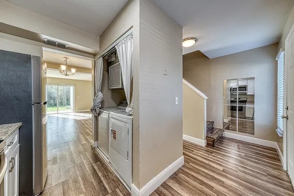 a view of a kitchen from the hallway with windows
