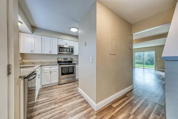 a kitchen with granite countertop a refrigerator and a stove