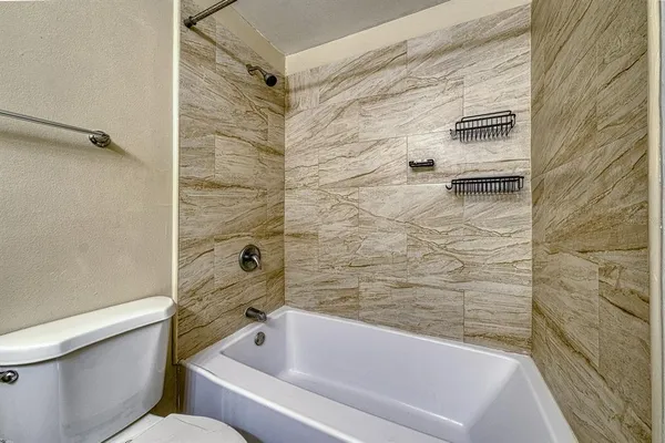 a bathroom with a bathtub and a shower