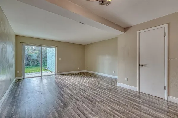 wooden floor in an empty room with a window