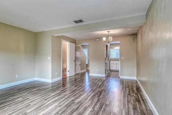 a view of an empty room and wooden floor