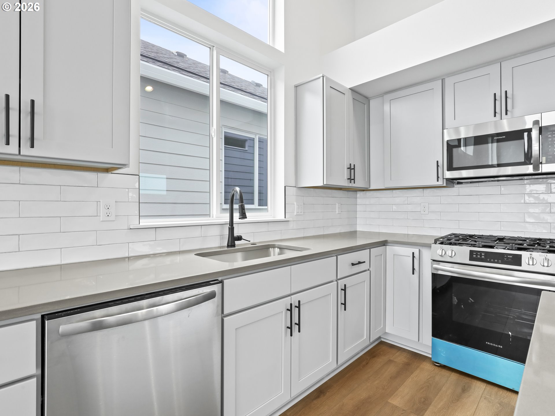 41870 Deschutes Avenue, Unit 11 Sandy, OR 97055 - Photo 5 of 43 a kitchen with stainless steel appliances granite countertop a sink a stove and microwave