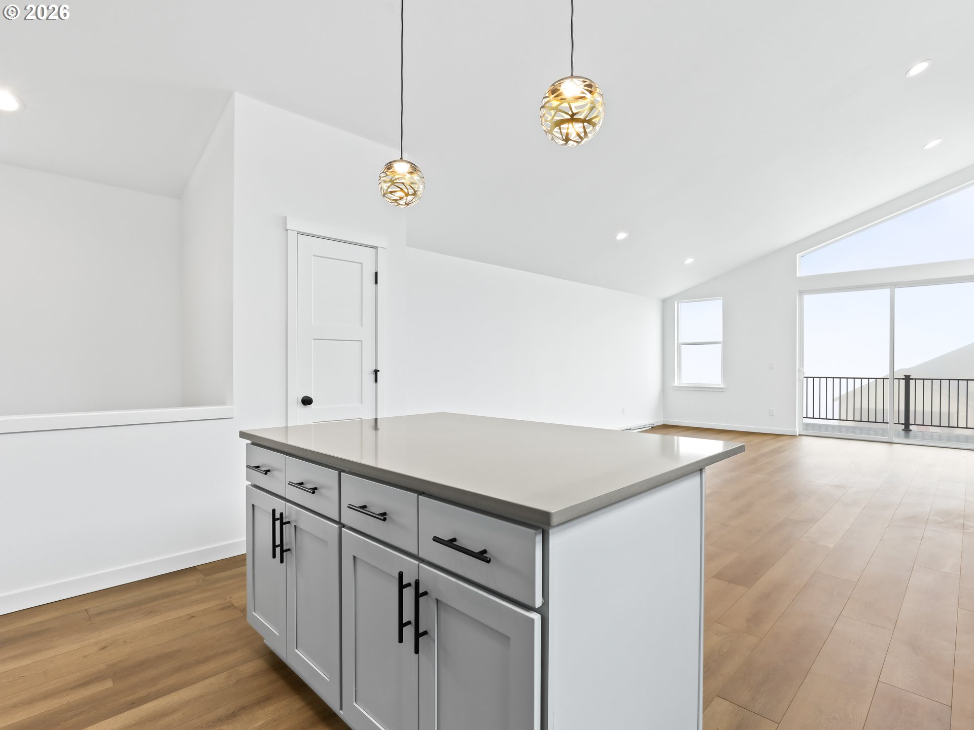 41870 Deschutes Avenue, Unit 11 Sandy, OR 97055 - Photo 7 of 43 a view of a kitchen with center island and wooden floor