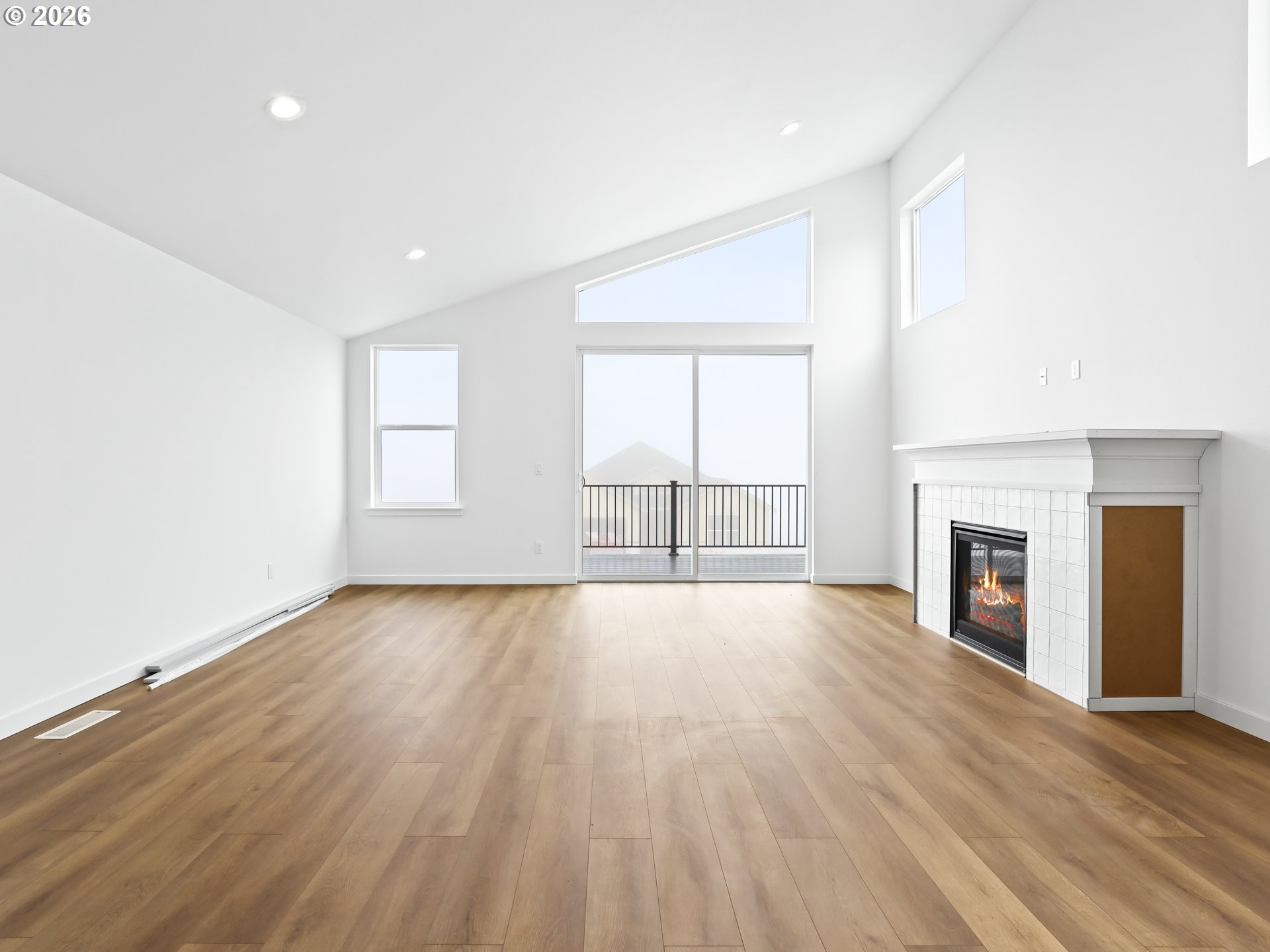 41870 Deschutes Avenue, Unit 11 Sandy, OR 97055 - Photo 9 of 43 an empty room with wooden floor fireplace and windows