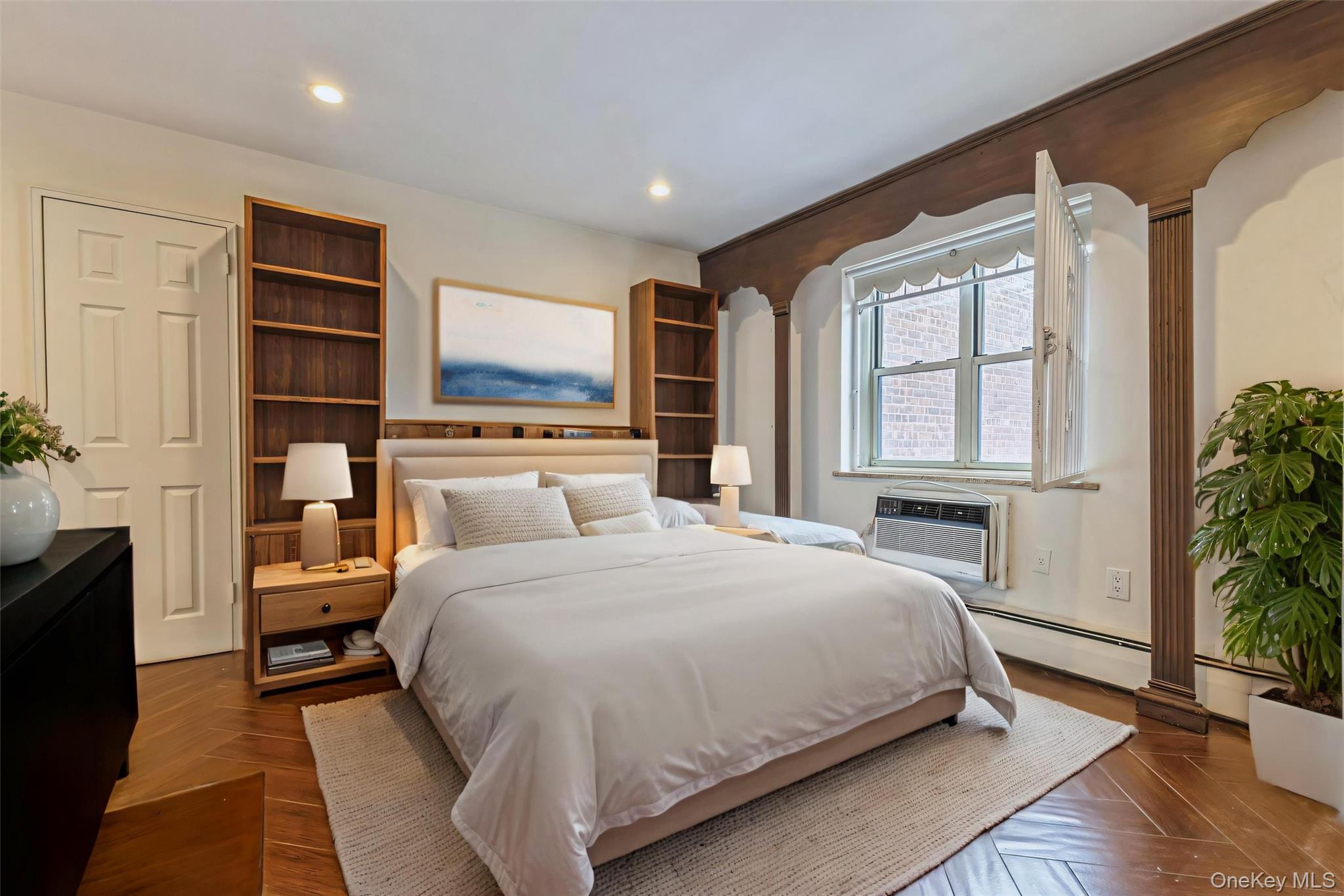 99-10 60th Avenue, Unit 6EE Queens, NY 11368 - Photo 6 of 14 Bedroom with a baseboard heating unit, recessed lighting, and an AC wall unit