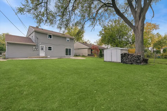 a view of a house with a yard and tree