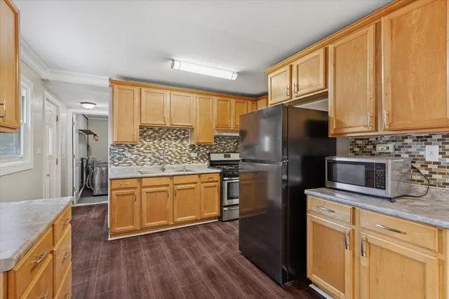 a kitchen with stainless steel appliances a refrigerator sink and microwave