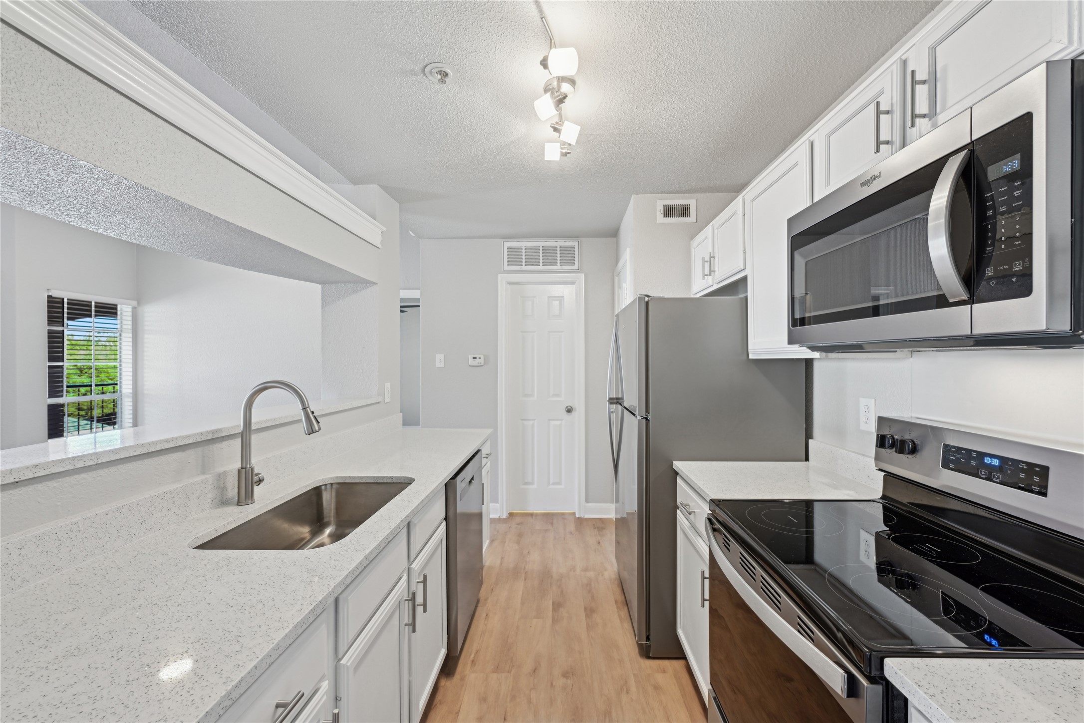10990 West Road, Unit 808 Houston, TX 77064 - Photo 12 of 19 a kitchen with stainless steel appliances kitchen island a sink stove and cabinets