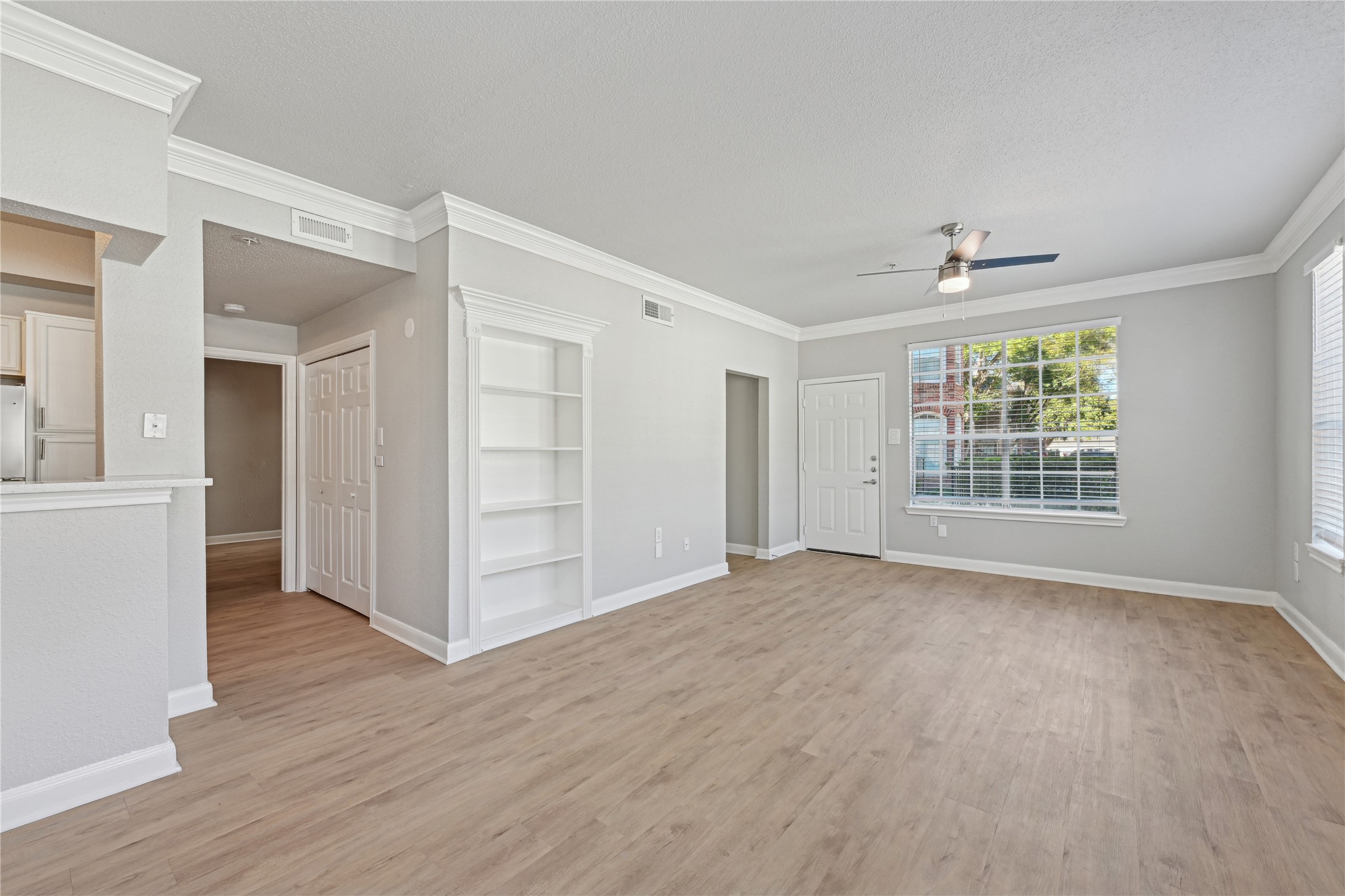 10990 West Road, Unit 808 Houston, TX 77064 - Photo 17 of 19 a view of an empty room with a window and wooden floor