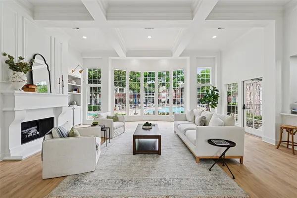 a living room with furniture fireplace and a large window
