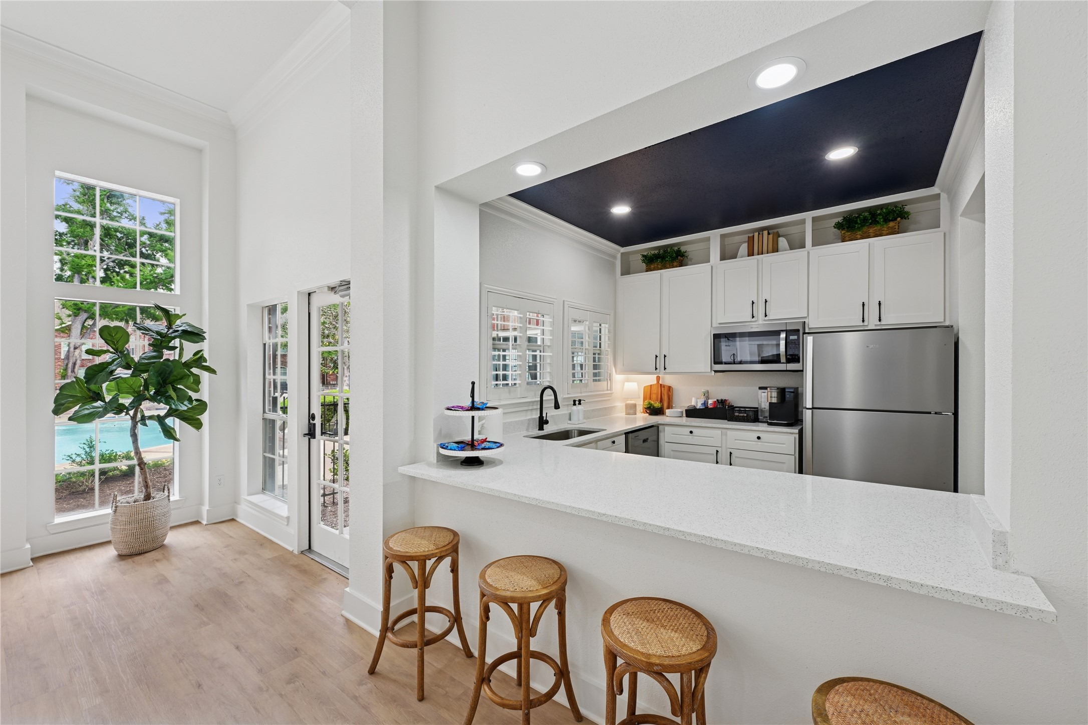 10990 West Road, Unit 808 Houston, TX 77064 - Photo 5 of 19 a kitchen with stainless steel appliances a refrigerator a stove a sink a oven with a dining table and chairs