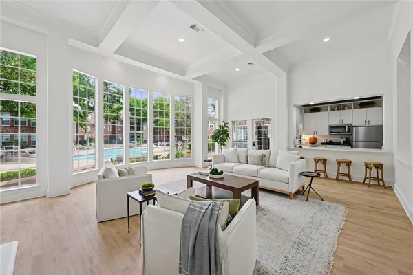 a living room with furniture and floor to ceiling windows