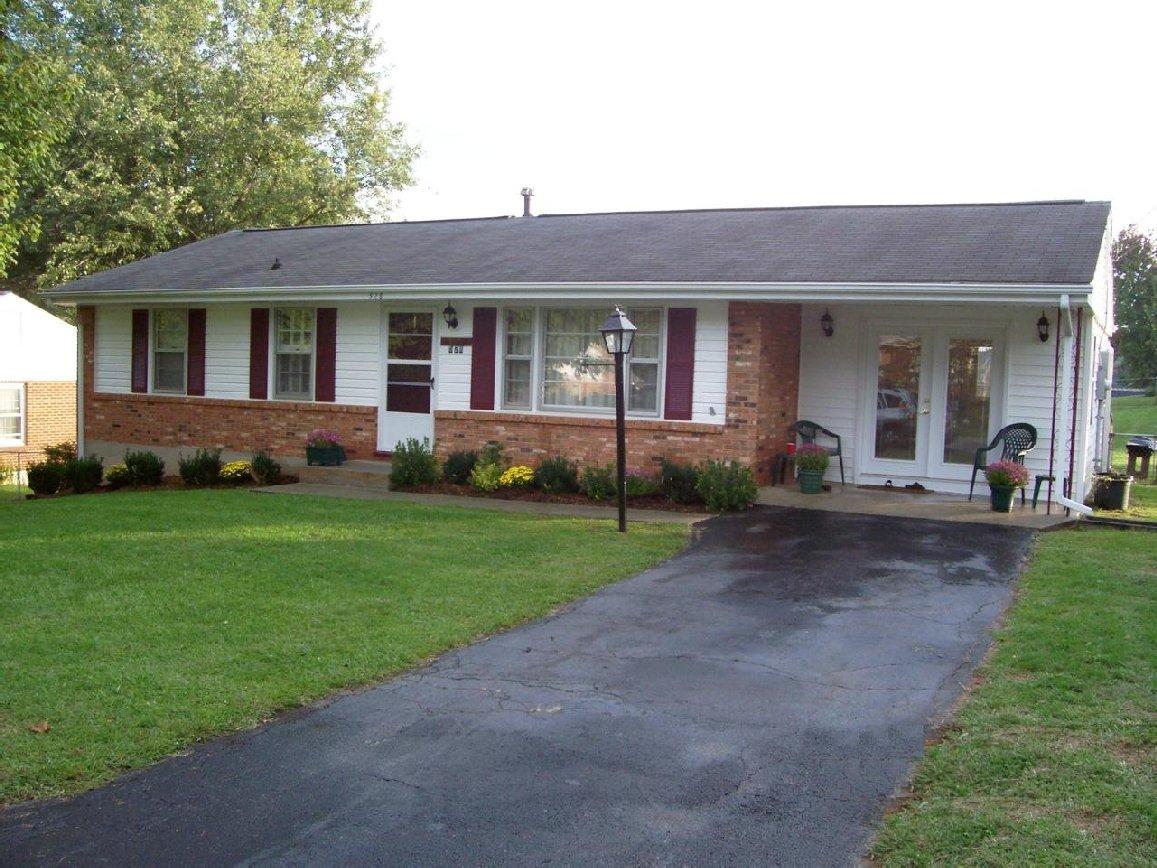 a front view of a house with a garden and plants