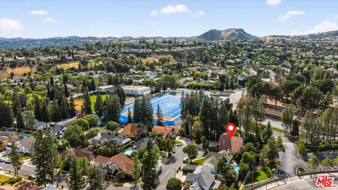 an aerial view of houses with yard